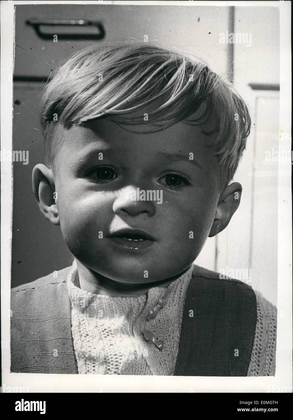 May 05, 1955 - The little boy who died twice - and is now in perfect health.:Twenty months old Martin Harris fell into the goldfish pond in the garden of his home in Raynes Park, Surrey. His mother found him floating face downwards - and pulled him out. The ambulance was called and 46 year old driver William Crabb and attendant Edward Dunning (51) turned Martin upside down and rocked him gently - has had stopped breathing. He starts to breathe again, but in Dunning's arm on way to Wimbledon Hospital - Martin died again Stock Photo