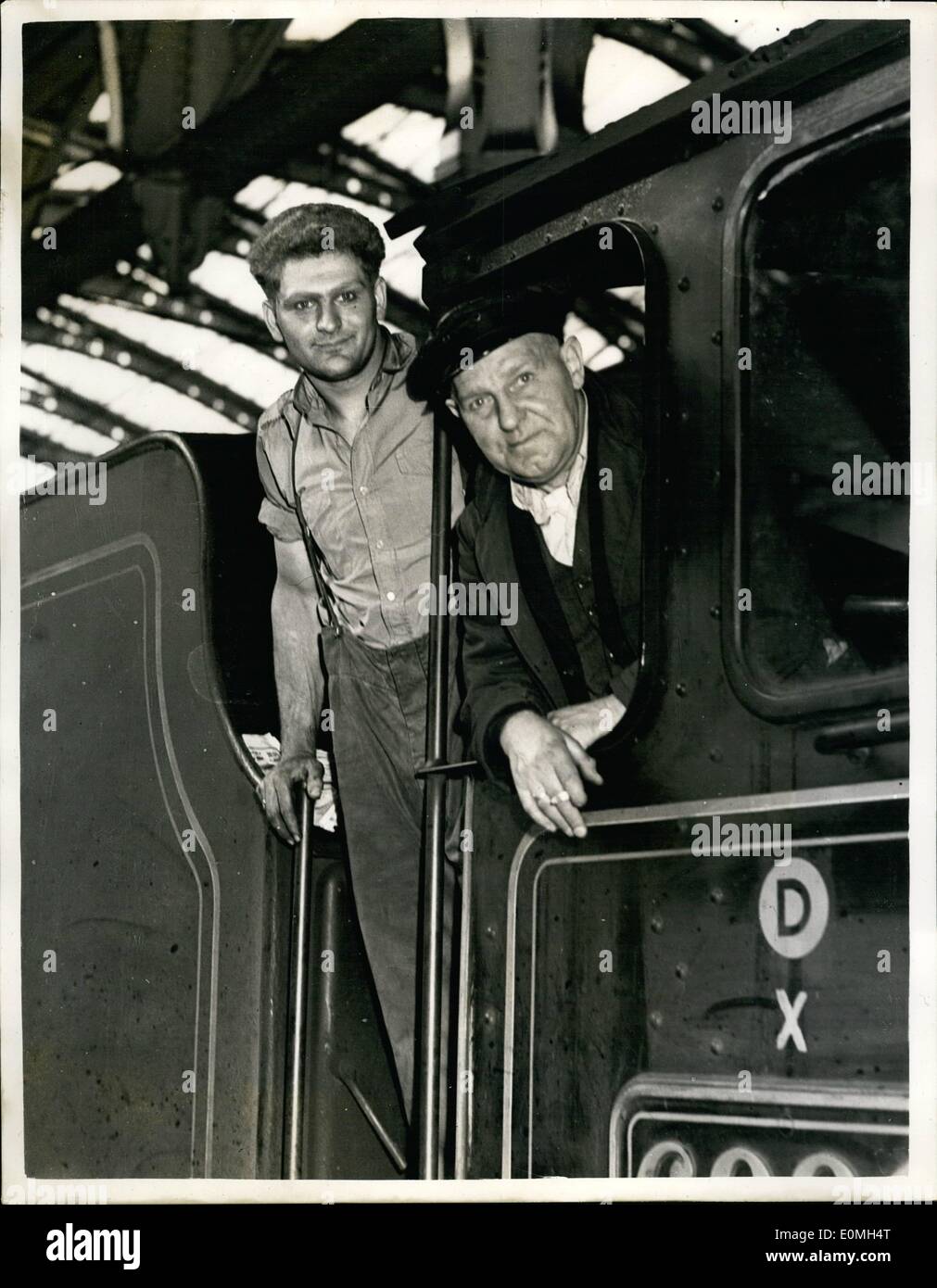 May 05, 1955 - Rail strike scenes. Stranded Holiday makers rescued.: A 23 year old fireman and his engine driver stepfather yesterday rescued 950 stranded holiday-makers. The two drove the only train from Plymouth to Paddington. When Bill Hare, fireman and member of the striking union learned out of his engine cab at Paddington, mothers with children rushed up to shake his hand. They cheered him and driver Harry Samuel. Bill and Harry both live in Taunton. Harry, who is 62, and an engine driver for 33 years, is a member of the N.U.R Stock Photo