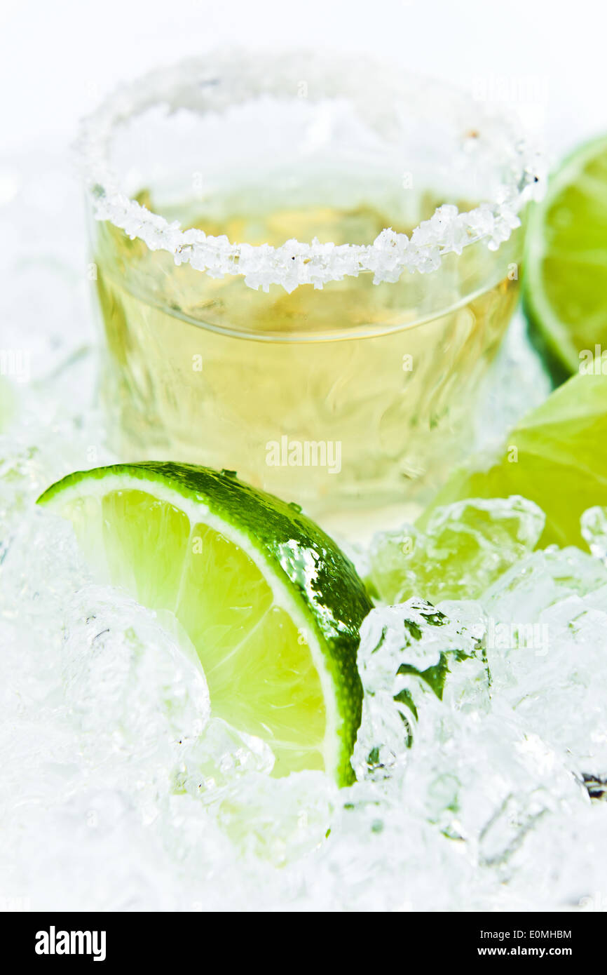 gold tequila with salt and lime on a ice Stock Photo Alamy