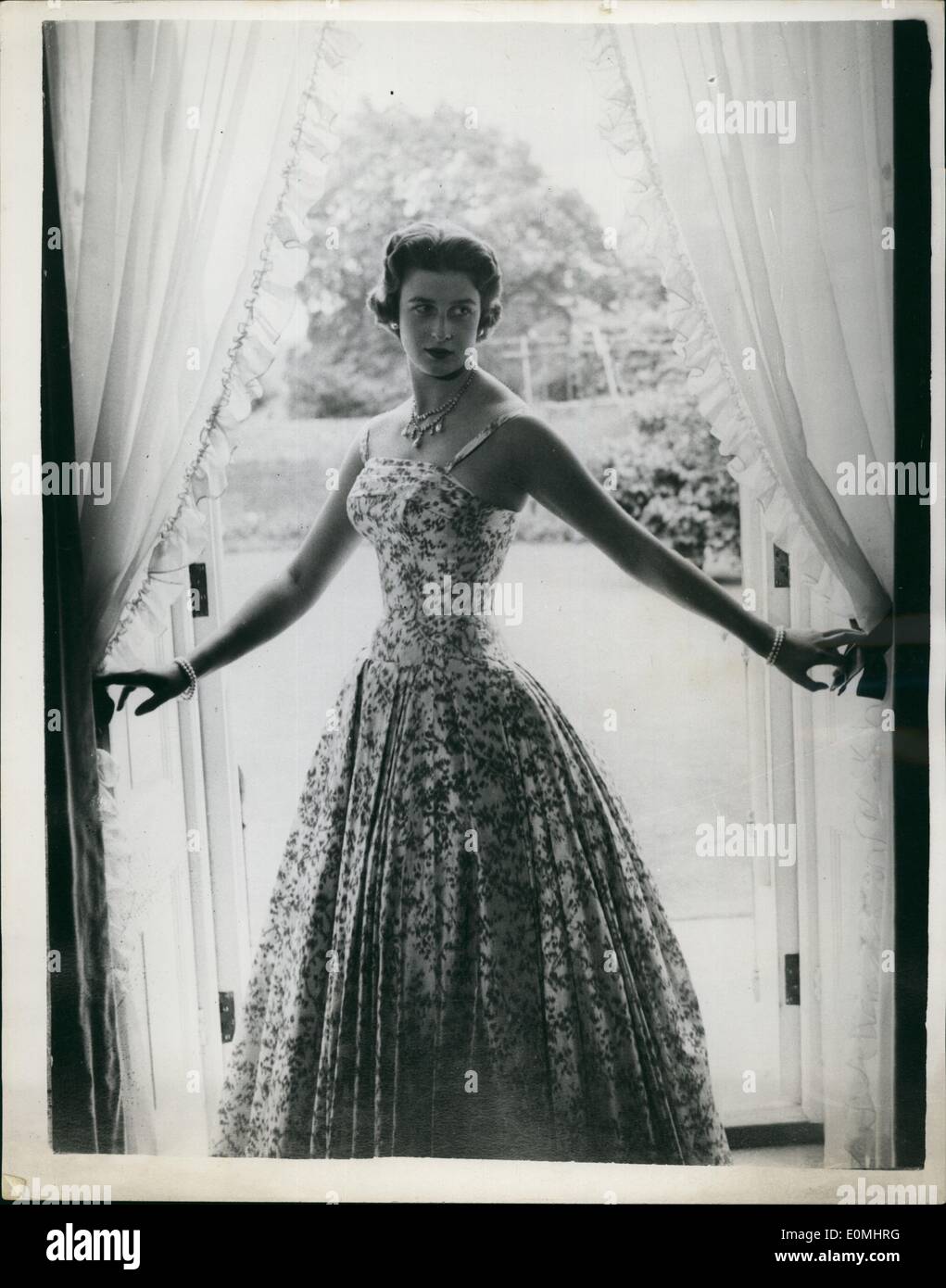 Aug. 08, 1955 - New Portrait Study Of H.R.H. Princess Alexandra: This new study of H.R.H. Princess Alexandra of Kent was made by Cecil Beaton in the Drawing Room at Kensington Palace, London - in July 1955. In this picture H.R.H. is wearing pearl car-rings, Diamond and Pearl necklace and Pearl bracelets with a red and white flowered evening gown. Stock Photo