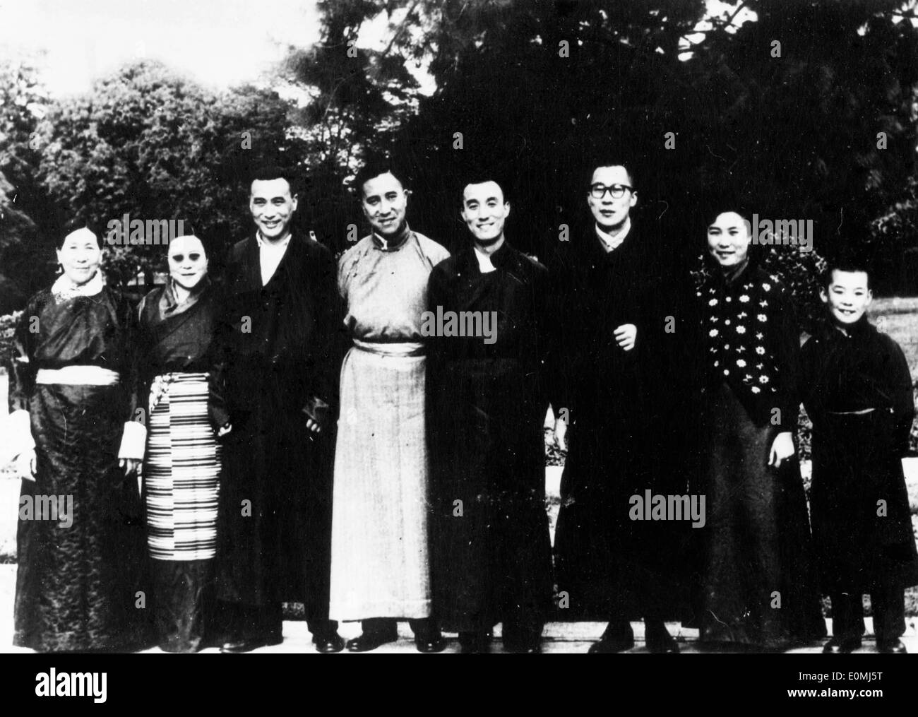 The 14th Dalai Lama standing with his family Stock Photo