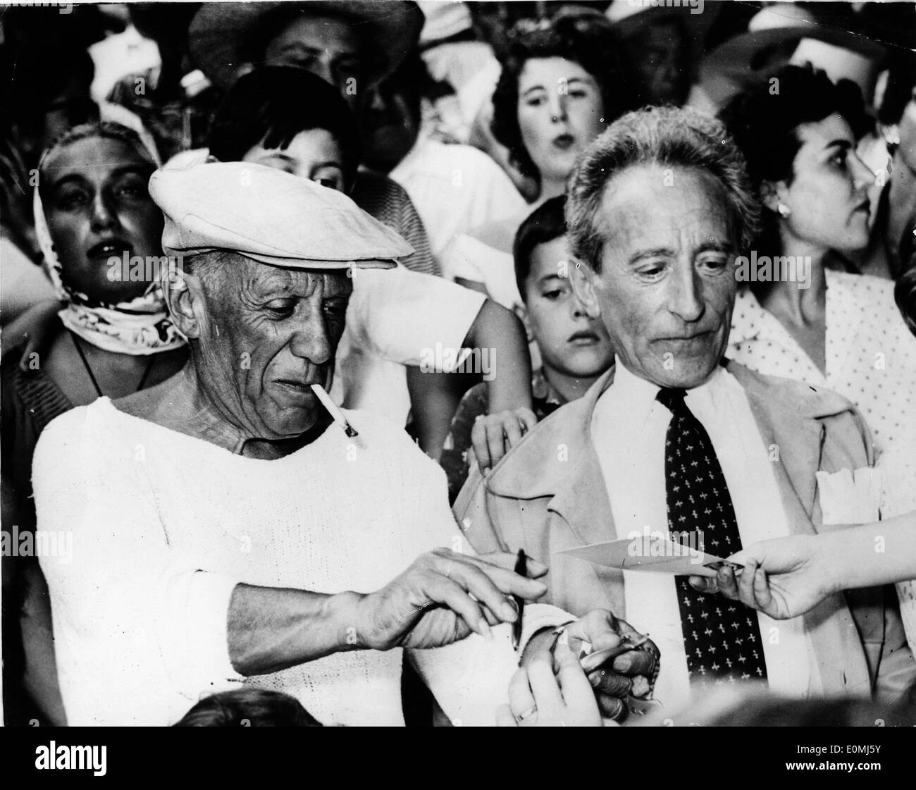 Artist Pablo Picasso sitting with Jean Cocteau at a bullfight Stock Photo