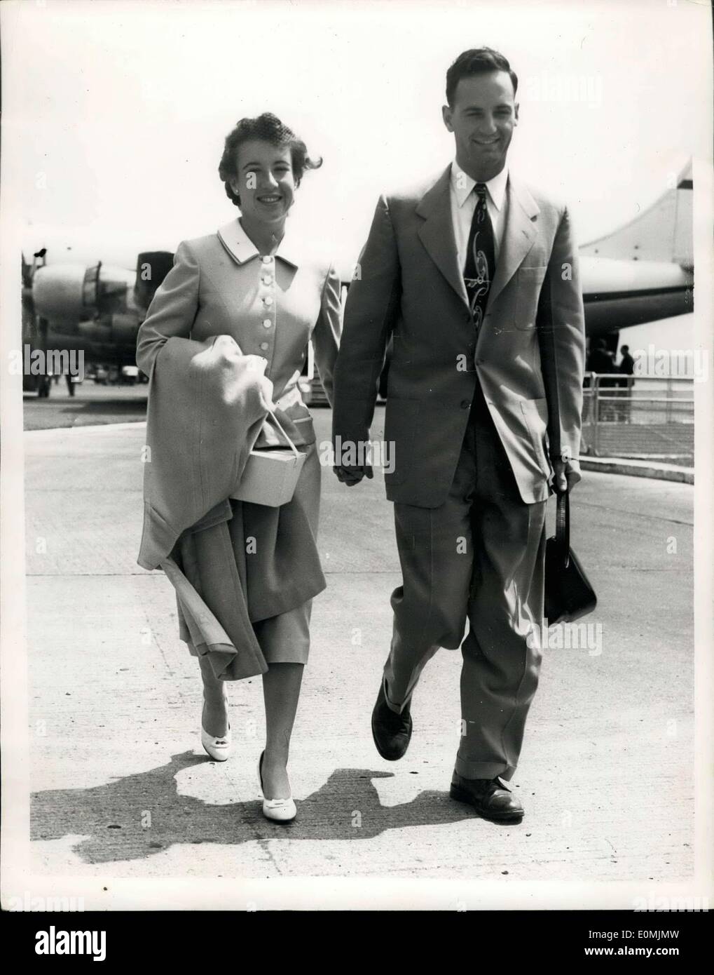 Jun. 17, 1955 - Maureen Connolly Arrives In London On Honeymoon Hand-In-Hand: Maureen Connolly the young American World Tennis Champion-and her husbnad of four dauys-Norman Brinker-American Olympic Horseman arrived at London report on the Wimbledon Championships. She is not defending her title. Photo shows. Maureen Connolly and husband Norman Brinker walk away from the aircraft hand-in-hand on their arrival at London Airport this morning. Stock Photo