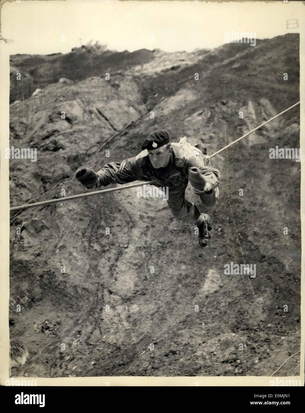 Jun. 17, 1955 - 17-6-55 Exercise runaground on the Isle of Wight. Flying Swallow - Students of the Staff Collages of the three services are taking part In ''Runaground VI'' Culver Cliff on the Isle of Wight - and today. The first phase consists of a Command Cliff assault up a 250 ft.high rock face. Keystone Photo Shows: A Marine Commando comes down the cliff in Flying Swallow style with the aid of a rope fixed to the body during the demonstration on Culver Cliff, Isle of Wight today. Stock Photo