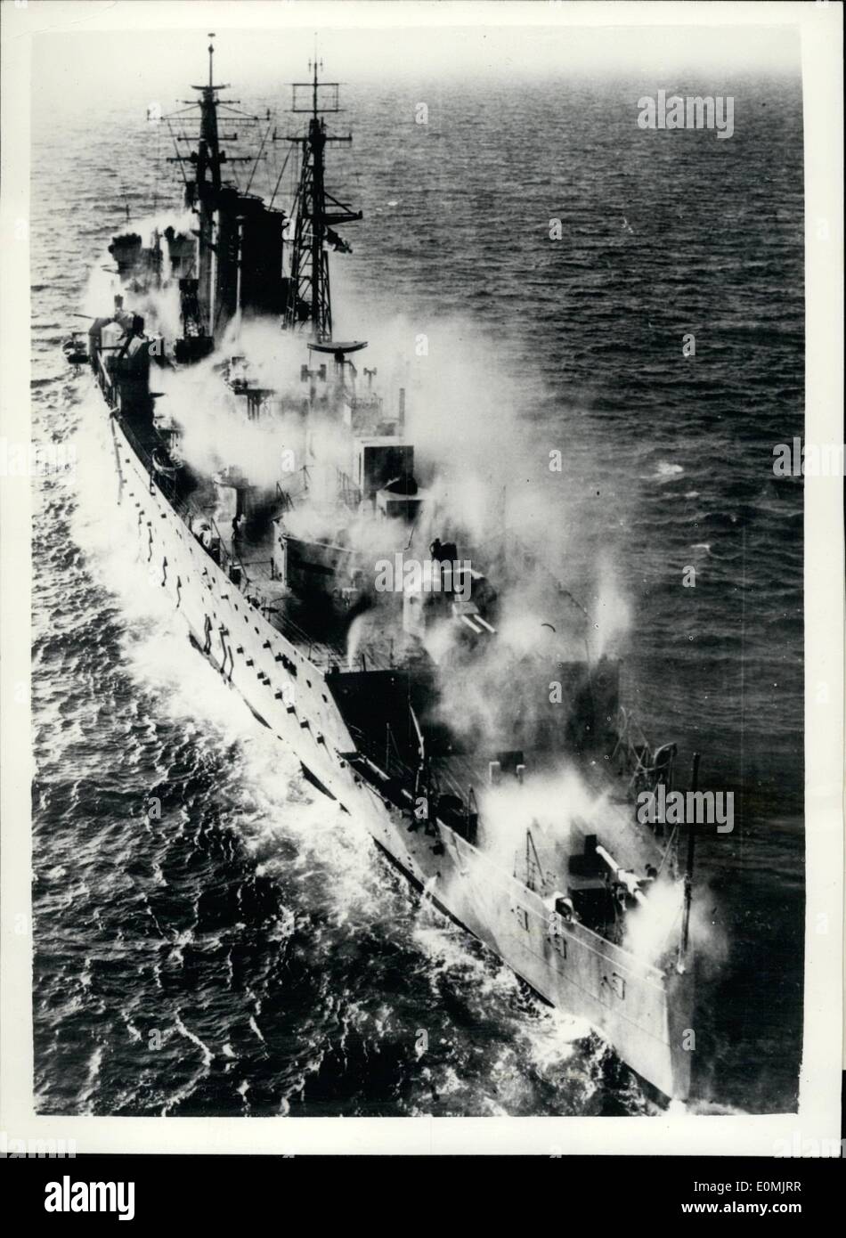 Sep. 09, 1955 - Navy's Trials Cruiser Returns to Britain. Anti atomic warfare test have been carried out off Malta by the British trials cruiser Cumberland, which arrived today at Devonport (Sept. 28). Photo Shows: - Water sprays fitted around the ship thoroughly washing the decks and superstructure, a method of protection, which would be used in war to keep ships free of radioactive particles. This method of protection, known as pre-wetting , would be employed in ships operating in the fall-out area or on the outer fringe of a region affected by an atomic explosion Stock Photo
