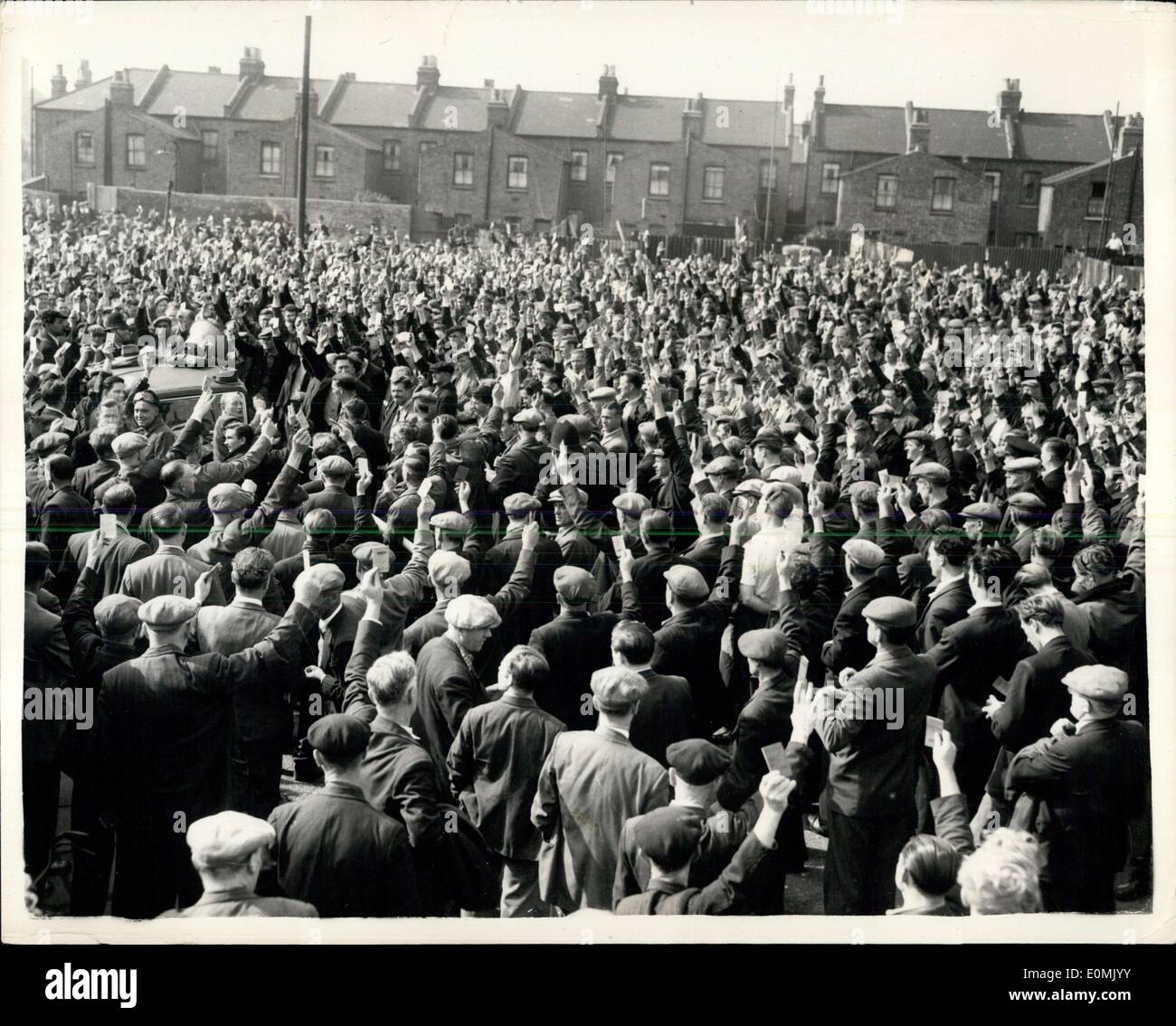 Jun. 27, 1955 - The Dock Strike, Northern Strikes Come To London. Strikers from the North marched to the London Docks from Tower Hill this morning - where they mat London men - who theya are trying to pursuade not to return to work.. some of the London man have gone back. Photo Shows: General view during the mass meeting of London and Provincial Dockers outside the London Docks this morning during the show of Union Cards in the vote to continue the strike. Stock Photo