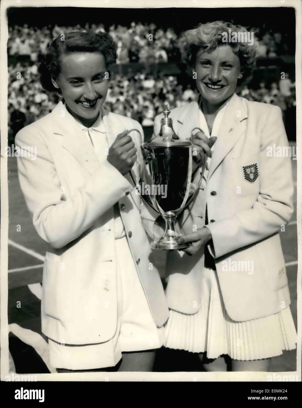 Jul. 07, 1955 - All-England Women's Doubles final. Mortimer and Shilcock beat Bloomer and ward. Photo shows Miss Angela Mortimer (left) and her partner Miss J. Shilcock with cup her partner Miss J. Shilcock with the cup after winning the Women's Double Final at Wimbledon this afternoon. They beat fellow countrywomen Miss S. Bloomer and Miss Pat Ward. Stock Photo