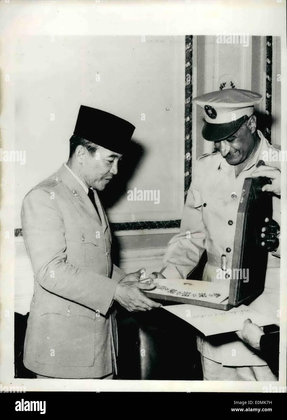 Jul. 07, 1955 - Prime Minister Nasser Welcomes Indonesian President to Cairo: President Ahmed Sockarno, of Indonesia, has arrived in Cairo for a five day State Visit. He was received on his arrival by Prime Minister Gamel Abdel Nasser, and members of the Revolution Command Council. Photo shows President Sukarno, of Indonesia, was decorated by Prime Minister Nasser with the Collar of the Order of the Nile. Here is Nasser handing over the box containing the Collar to the President. Stock Photo