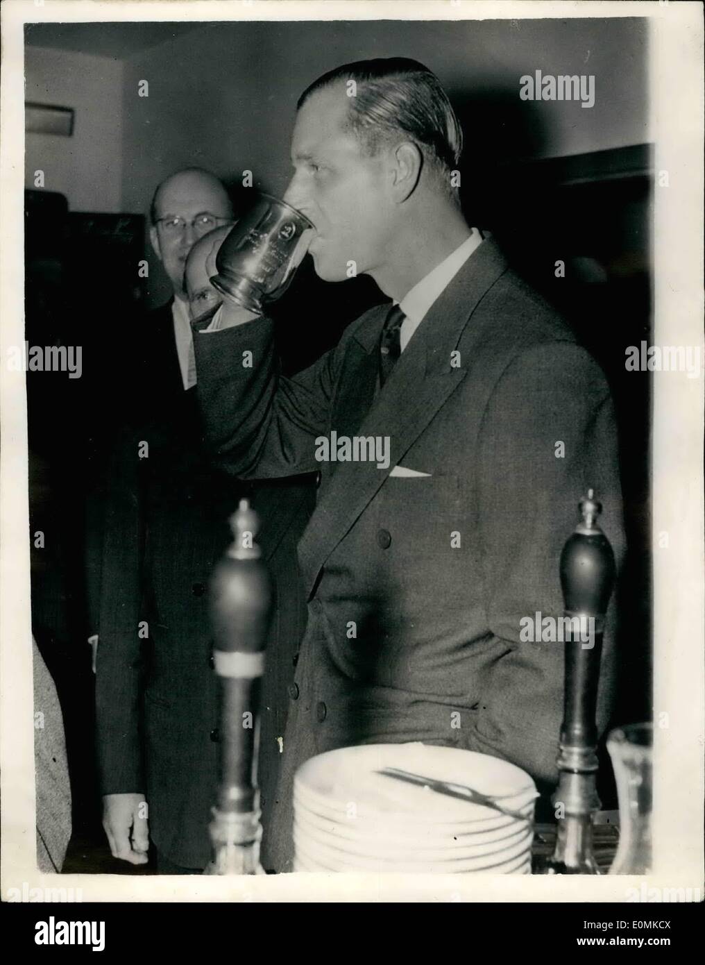 Oct. 10, 1955 - The Duke of Edinburgh visits the British trade fair in Copenhagen: The Duke of Edinburgh, who is in Denmark on a five-day visit, paid a visit to the British Trade Fair in Copenhagen. He spent two hours touring the exhibition and visited the British Inn Britania, where he had a beer in a silber tankard, which was afterwards given him as a souvenir. Photo shows the Duke of Edinburgh takes a drink of beer from the silver tankards in the British inn Britania. Stock Photo