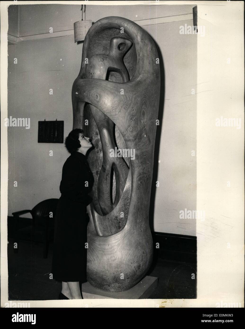 Oct. 10, 1955 - Exhibition Of Recent Sculpture By Henry Moore At Leicester Galleries: An exhibition of recent sculpture by Henry Moore, opens today at the Leicester Galleries. Photo Shows Sally Winkleman, of Hampstead looking at Henry Moore's ''Upright Exterior and Interior forms'' - win elm wood - at this morning's private view. Stock Photo