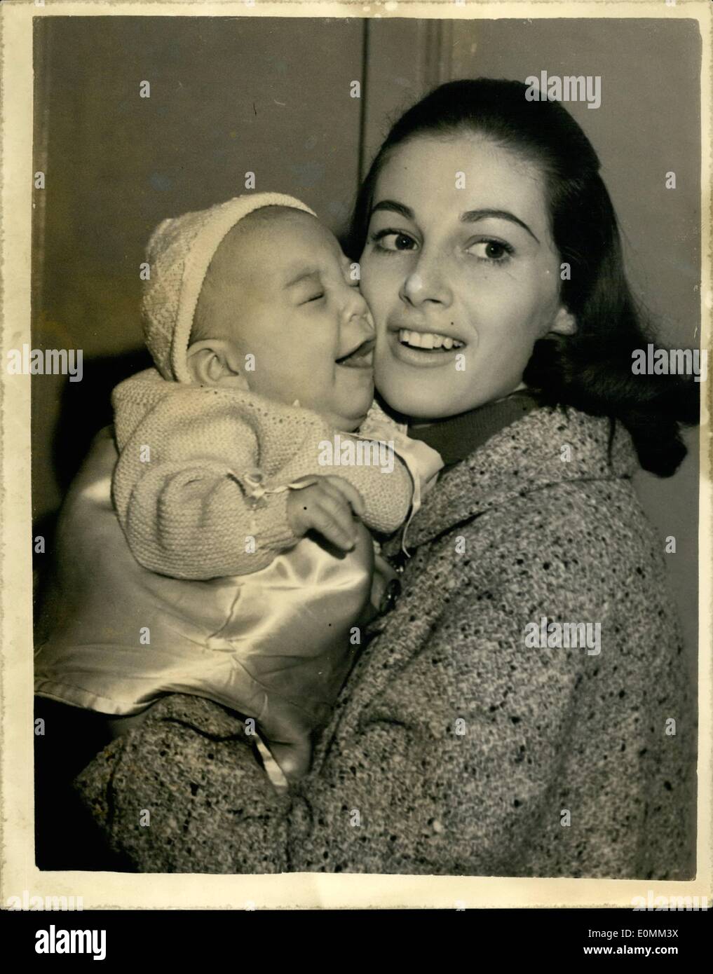 Nov. 11, 1955 - Pier Angeli meets her ''Miracle Baby'' . He arrives at London airport. Screen star Pier Angeli who is filming in this country went to London airport this evening to meet her baby three months old Perry known as the ''Miracle Baby'' because he survived after Pier's pelvis was fractured when a plane hit an air pocket , Pier is the wife of American born Italian crooner Vic Damone. Photo shows Pier Angeli with her baby on his arrival at London airport this evening. Stock Photo