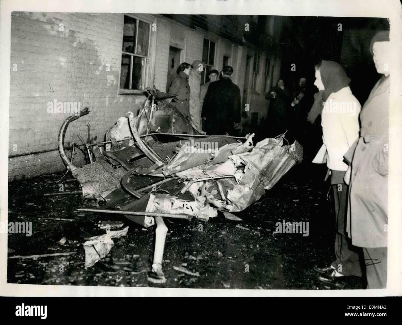 Jan. 01, 1956 - R.A.F PLANE CRASHES IN VILLAGE HIGH STREET.. PART OF THE WRECKAGE. At least one person was killed and a number were injured when an R.A.F. plane crashed this afternoon in the High Street at Wadhurst, Sussex.. A hotel and number of shops were damaged.. The plane burst into flames.. Keystone Photo Shows:- Part of the aircraft wreckage in center of the Village Street of Wadhurst this evening. Stock Photo