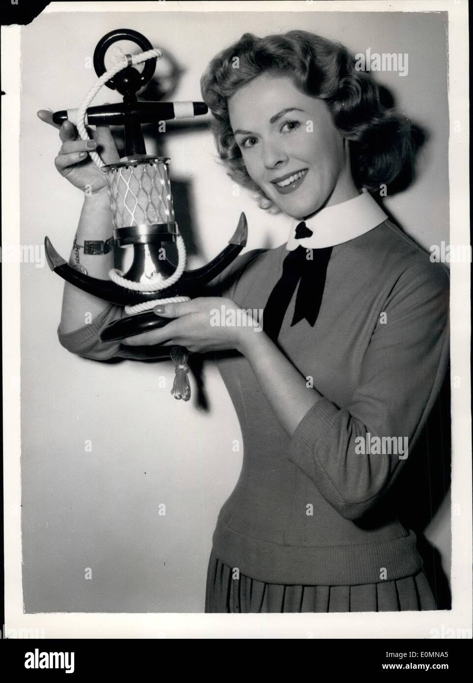 Jan. 01, 1956 - British Furniture Exhibition opens.. The 'Anchor' Table Lamp: Many new styles and designs were to be seen at the British Furniture Exhibition which opened this morning at Earls Court.. Picture Shows: Miss Pat Manwaring of Epsom, Surrey- admires a novel table lamp- in the shape of an anchor- at the exhibition this morning. Stock Photo