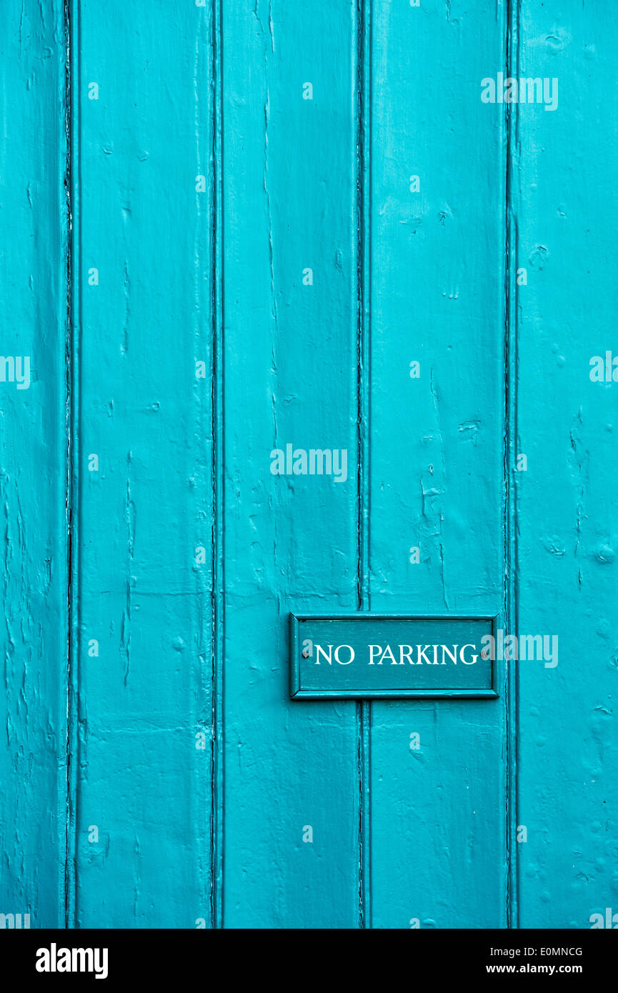 No Parking sign on turquoise painted wood paneling Stock Photo