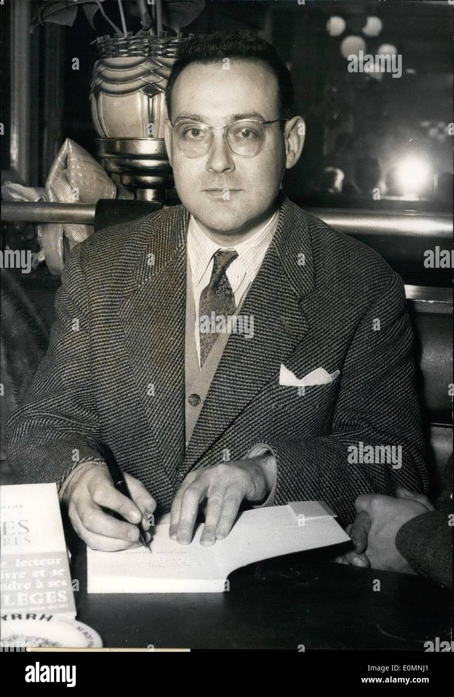 Jan. 01, 1956 - The Guillaume Apollinaire Prize to Robert Sabatier - The Guillaume Apollinaire Prize, which is awarded every year to a poetry work of modern inspiration went this year to Robert Sabatier for his poems: Les Fetes Solaires (Solar Festivities). OPS: R. Sabatier signing his book Stock Photo