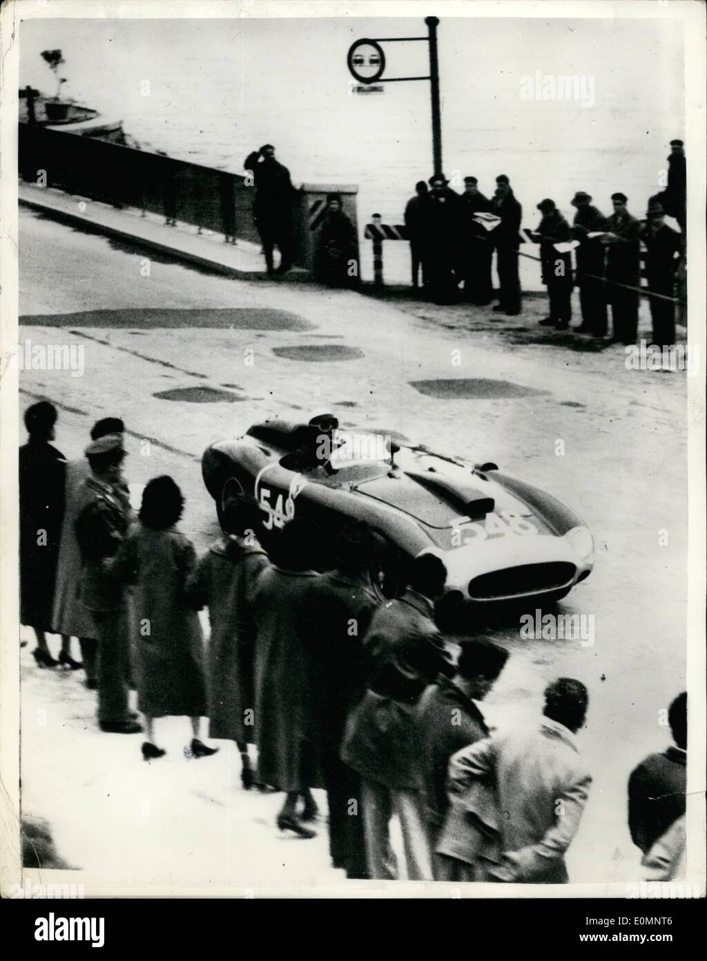 Apr. 04, 1956 - Castelotti wins Mille Miglia road race. Average speed of 85 M.P.H. The Annual 1,000 mile Mille Miglia car race through Italy was won by 24 year old Figenio Castelotti in a 12 cylinder 3 1/2 litre Ferrari at an average speed of 85 m.p.h. Photo shows Onlookers watch as Castelotti races through Peschiers during the Mille Miglia which he won. Stock Photo