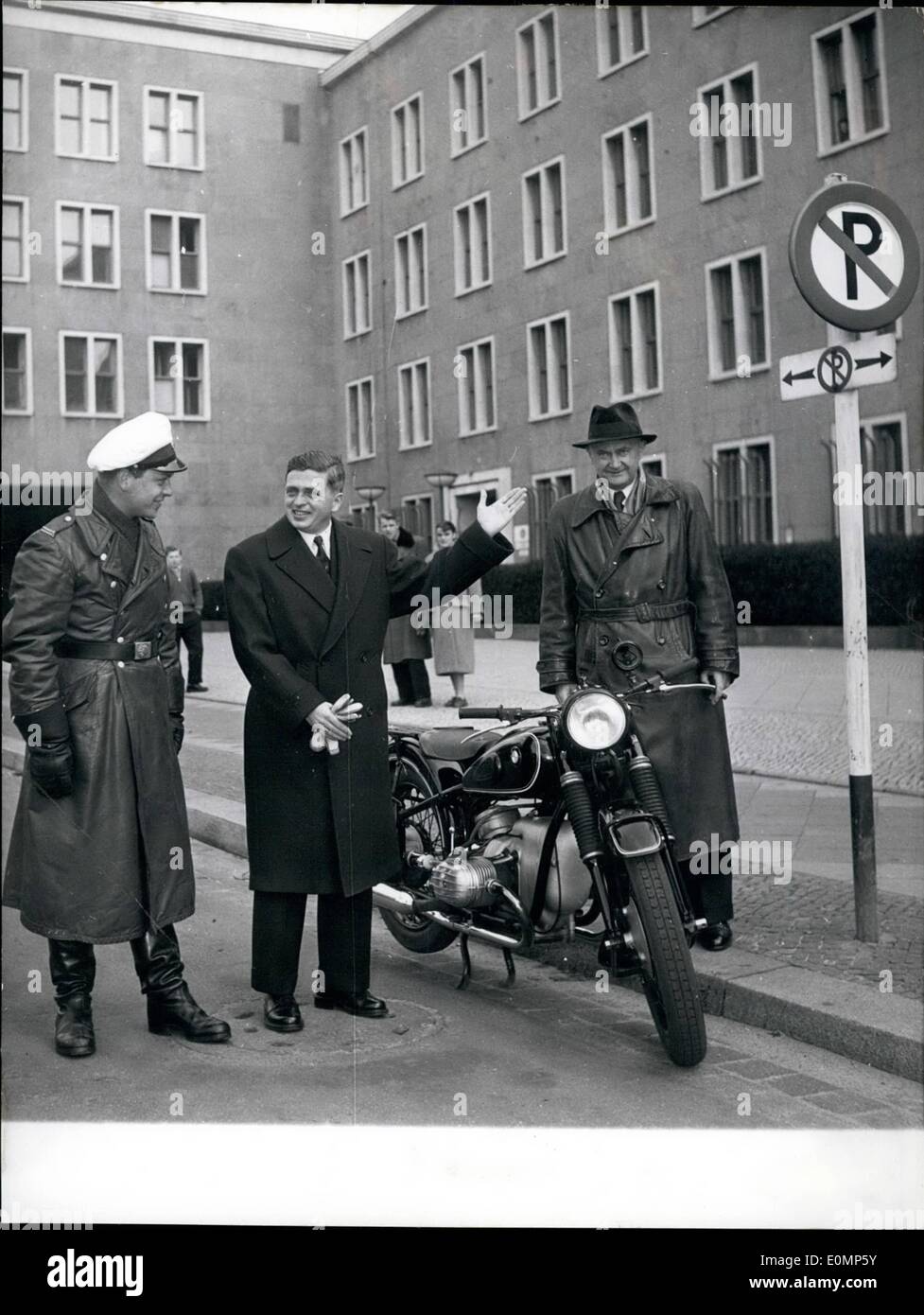 Apr. 04, 1956 - The Paris traffic-President in Berlin.; Leaving the presidium, Mr. Armand Bollinger from Paris just saw a Berlin policeman (a so called white mouse) who was about to park his machine quite wrong as posters declares. Dr. Stumm, the Berlin police-president could not but smile on what Mr. Bollinger (middle) was telling to the policeman because of his wrong behavior. Stock Photo