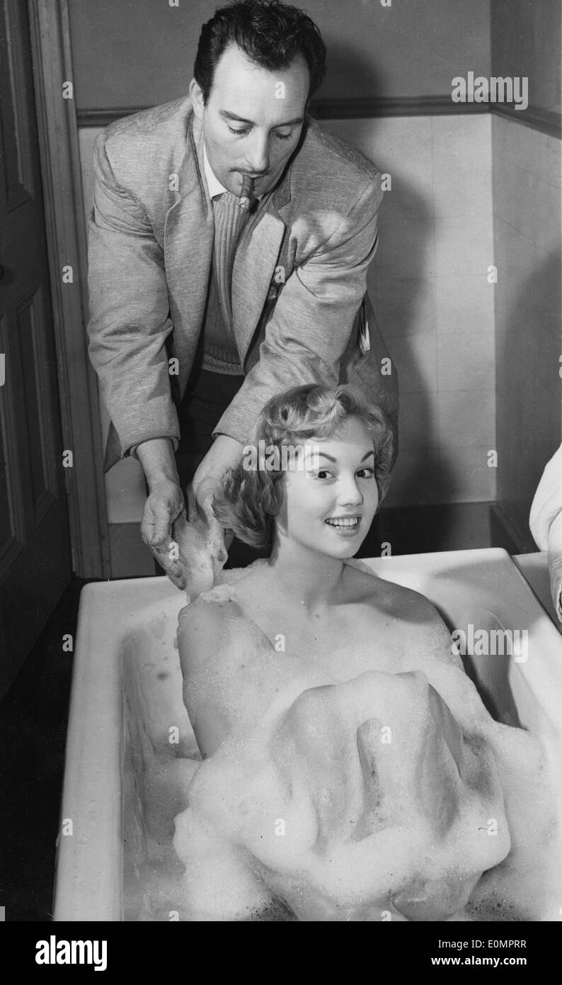Feb. 8, 1956 - Director VAL GUEST lends a hand to actress MYLENE DEMONGEOT in a bubble bath on set of the film, 'It's a Great Life,' at Shepperton Studios. Stock Photo