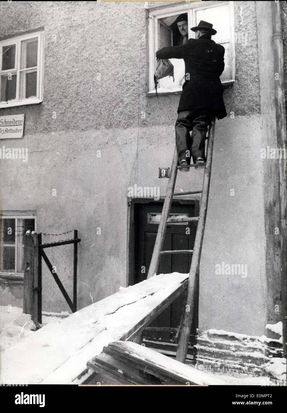 Feb. 11, 1956 - Food by the window; The high water catastrophe in Vilshofen became more and more critical. Dors of teh houses are frozen and peoples are cut off. So the town major Hans Sterr supplies the 70 years old dressmaker Franz Arthuber with food through the window of the first floor. Stock Photo