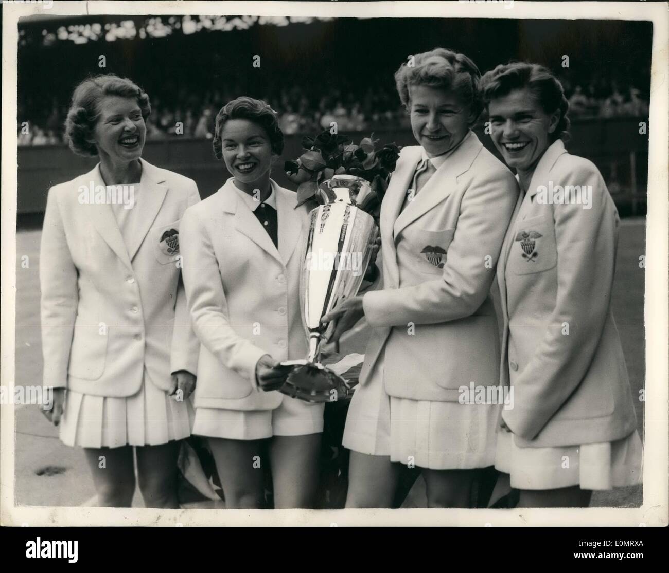 Jun. 06, 1956 - Wightman Cup Tennis At Wimbledon, American Team Wins. Photo Shows: L-R - Mrs. Dorothy Knode; Mrs. Beverley Flietz (nee Baker); Louise Brough and Shirley Fry in happy mood as they surround the Wightman Cup - after their victory at Wimbledon this afternoon. Stock Photo