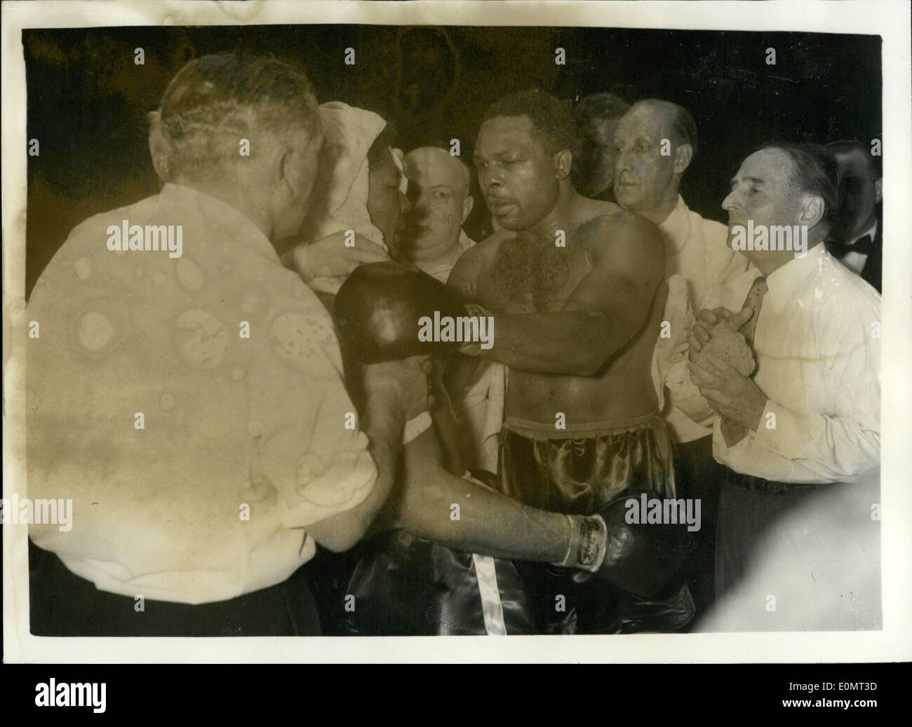 Jun. 06, 1956 - Archie Moore retails his light - heavy weight title. Beats Yolande Pompey in tenth round. Archie Moore the light heavy weight champion on the world - last night retained his title, when he beat Trinidad's Yola De Pompey - the referee stopping the contest in the tenth round - at Harringay. photo shows Archie Moore Inspects the injuries which he inflicted on Yolande Pompey after his victory at Harringay last night. Stock Photo