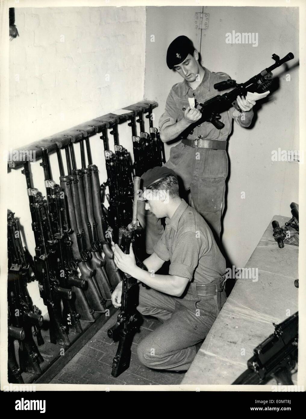 Aug. 08, 1956 - Operation Suez Commences. Checking Arms - at Warley Barracks., Essex - today -owing to the Suez Canal Emergency. Some have been recalled from leave. Photo shows Checking arms in the Armour b- at The Barracks today. PTE. John Bailey (19) fromwellington, Shropshire (nearest camera) and L/CPL. John Graham of R.Em.E. from liverpool. He is 19. Stock Photo