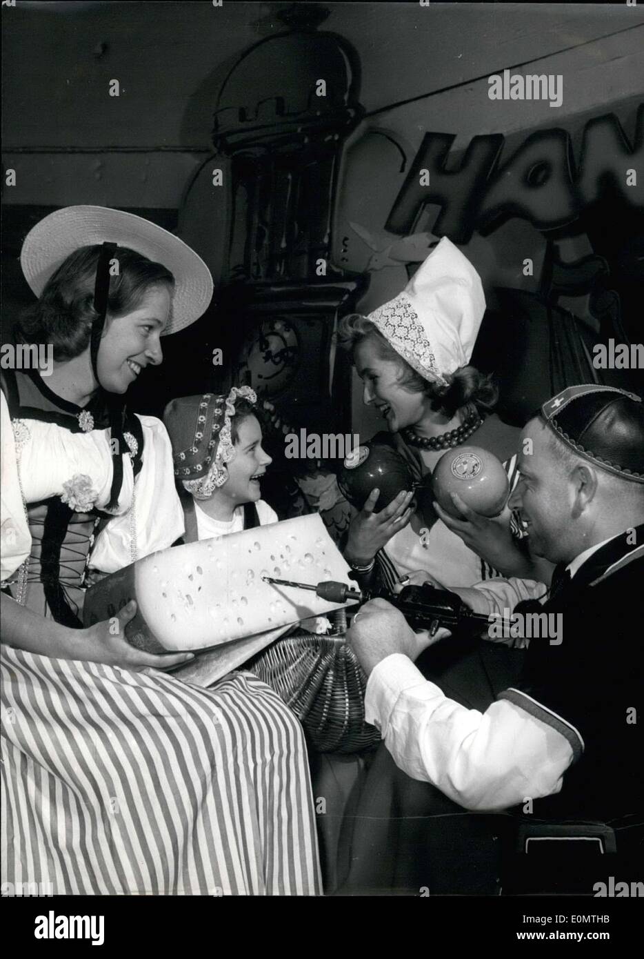 Aug. 24, 1956 - The LEFA, ''die Norddeutsche Lebensmittel Fachausstellung'' or the ''North German Food Exhibition'' took place in Hamburg. One young Dutch girl asked how they put the holes in Swiss cheese and the Swiss representative, who is there for the first time, humorously shows how to do it. Stock Photo