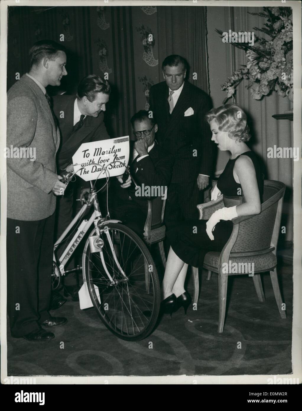 Jul. 07, 1956 - Marilyn Monroe gets her cycle : During a press conference at London's Savoy Hotel to Marilyn Monroe last night she was presented with a cycle. This was done after she had said that she would like to ride around surrey's country lanes on a cycle. Photo shows The cycle is handed over to Marilyn as husband Arthur Miller and Sir Laurence Olivier look on. Stock Photo