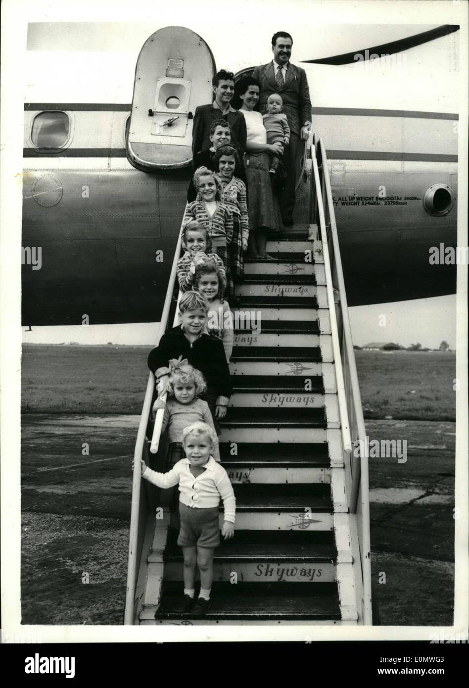 Jul. 07, 1956 - The Ten Little McAndrews Fly Home: Ten little McAndrews flew home together with father and mother today, Sergeant John McAndrew and his Maltess wife Francis. The children, five boys and five girls, range from 14 years to nine months. Four of them were born to Britain, four in Maltam, and two in Singapore. The family left Singapore by air and arrived Stenstead Airport, Essex, today. Sergeant McAndrew is 44 and come from County Maye, Ireland. Photo show The McAndrew family pictured on the steps of the plane on their arrival at Stanstead Airport Stock Photo