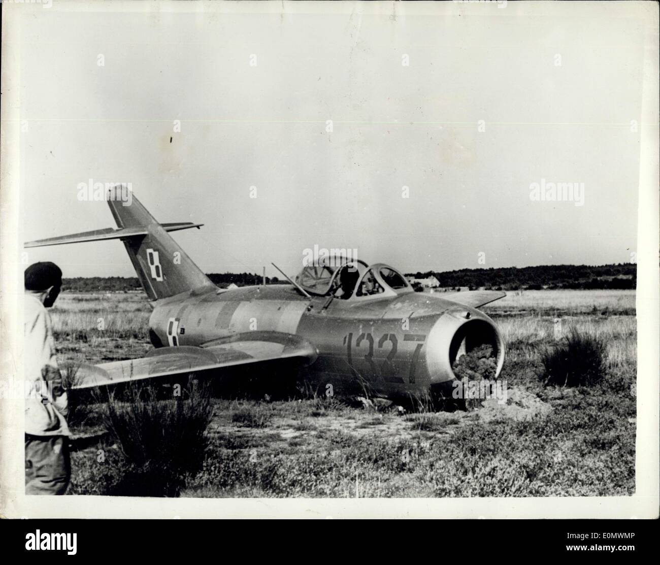 Sep. 27, 1956 - A Polish Air Force Lieutenant landed one of the latest type MIG jet fighters on the tiny airfield at Roenne on the Baltic Island of Bornholm and asked for political asylum. The MIG is of a design previously unknown to Western experts. It is believed to be an improved version of the MIG 15. The wing of the plane was damaged when the pilot landed the aircraft on an unfinished part of the airfield. Photo Shows: View of the MIG aircraft, after landing on the Danish Island of Bornholm. Stock Photo