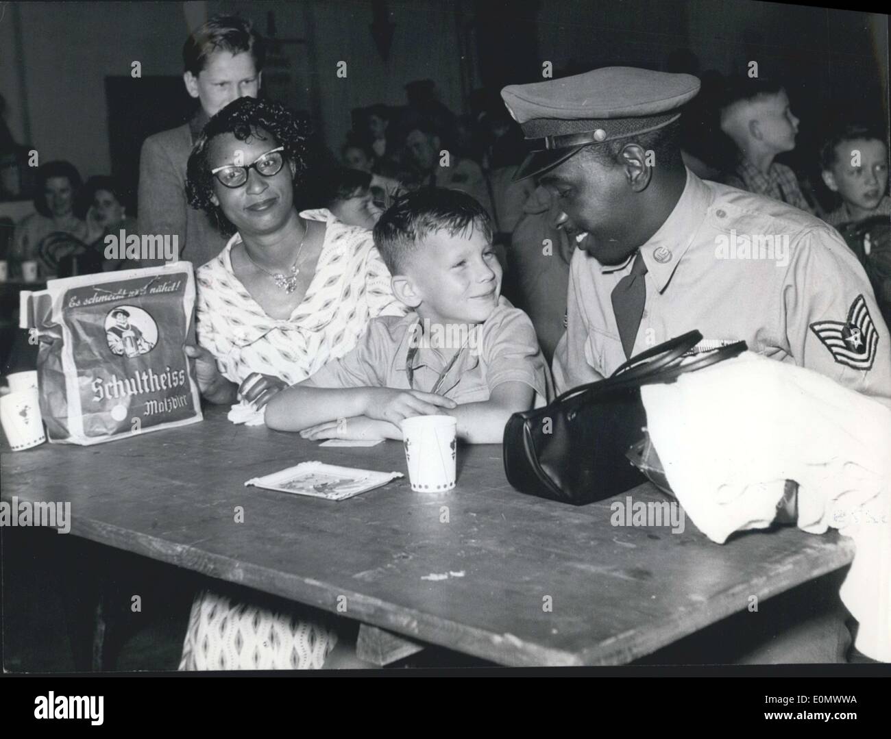 Jul. 11, 1956 - Pictured is Sergeant James E. Carter and his wife as they meet six year old Hans-Juergen Trosiener. The sergeant was a participant in the children's airlift in West Germany. Stock Photo