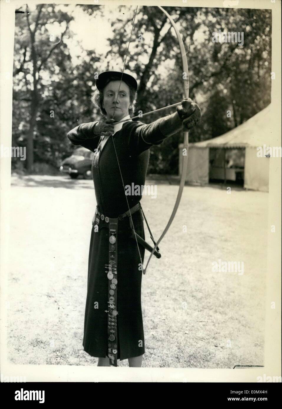 Jul. 25, 1956 - Grand National Archery Meeting. British Champion takes aim: The 103rd meeting of the Grand National Archery Society was held today at Worcester College, Oxford. Photo shows Mrs. VyVyan Patricia Flower the British Champion taking a practice aim before a match today with some of her many awards on a belt at Oxford. Stock Photo