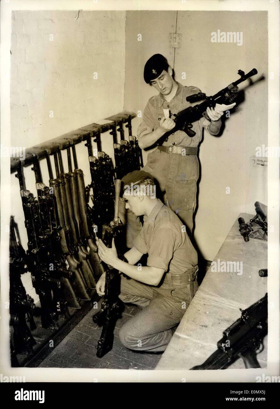 Aug. 03, 1956 - Operation Suez commence's checking arms - at Warley Barracks.: Men of the Oxford and Bucks Light Infantry were to be seen preparing for duty at the Warley Barracks, Essez - today - owing to the Suez Canal Emergency. Some have been recalled from leave. Photo shows checking arms in the armoury - at the Barracks today. PTE. John Bailey (19) from Wellington Shrepshire (nearest camera) and L/CPL.John Graham of R.E.M.E. from Liverpool. He is 19. Stock Photo