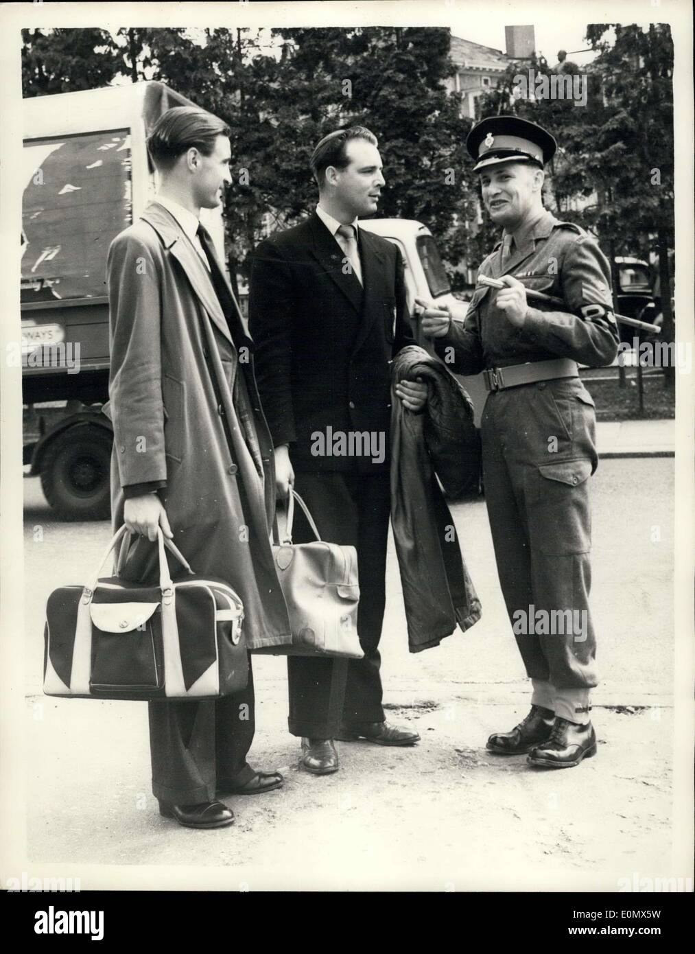 Aug. 03, 1956 - Operation Suez Begings. Life Guards recalled from leave.: Men of the Life Guards were to b seen at Combermere Barracks, Windsor, this morning packing for overseas cuty - oving to the Suez Canal emergecny.: Photo shows L-R: Trooper R. Pidcock of Chesterfield, Derby and CPL. of the horse L.V. Barratt of Wolverhampton - both recalled from leave - talking to CPL. of the Horse K. Morgan of the Military Police - as they arrive at Combermere Barracks today. Stock Photo