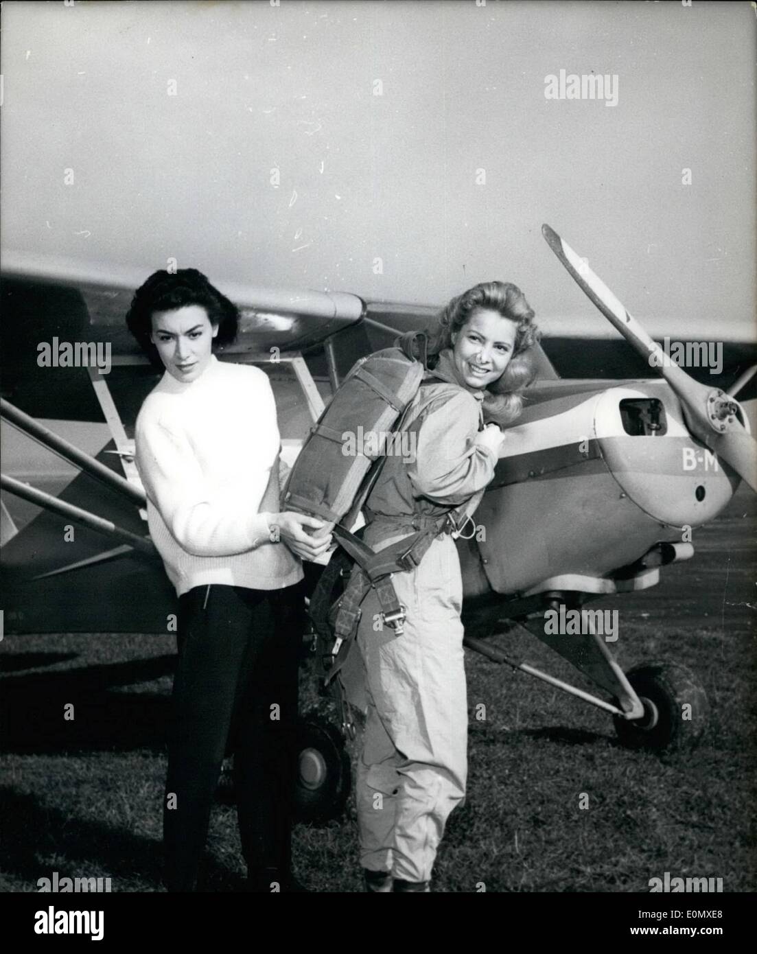 Feb. 02, 1957 - Colette Duval Trains Actress In Parachute Jumping: Genevieve Kervine, the young French screen actress, impersonates in ''Paris Music-Hall'' (a film now in the making) a Paris mannequin who turns a parachutist. Colette Duval who did so in real life was selected to give lessons to the actress in parachute jumping. Colette Duval adjusts the parachute for her actress pupil during the training at Toussus-le-Noble, near Paris, yesterday. Stock Photo