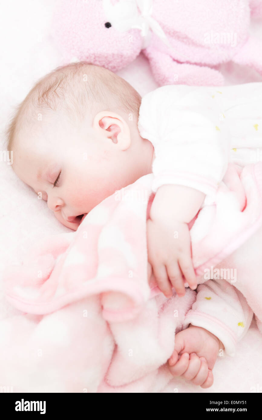 Cute baby girl sleeping in her crib Stock Photo - Alamy