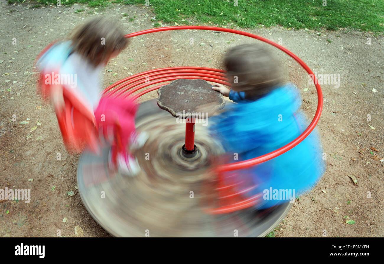 Children on red carousel spinning round Stock Photo Alamy
