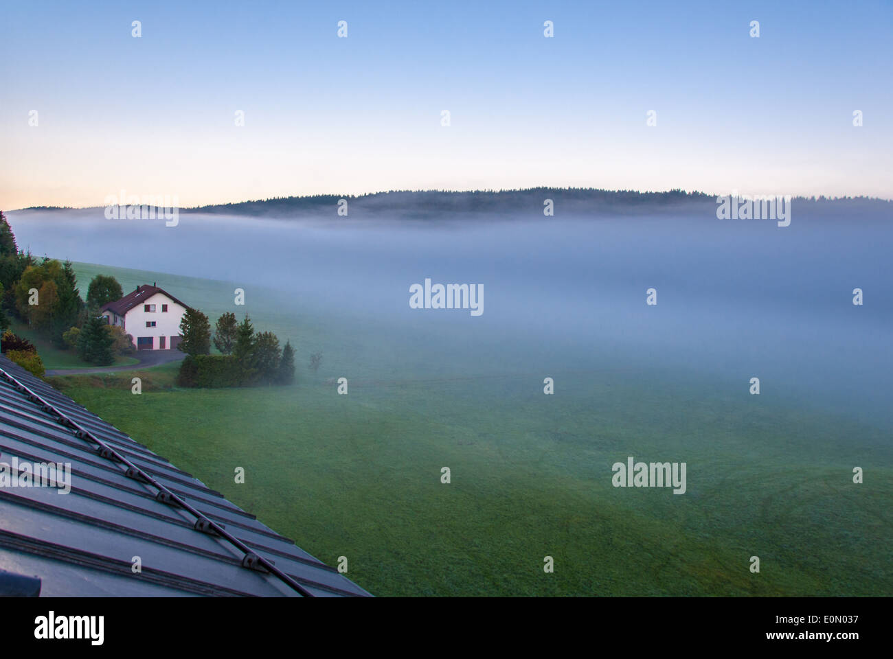 View of Le Brassus, a little village in the northern Switzerland, with a thick fog early in the morning in a winter day. Stock Photo