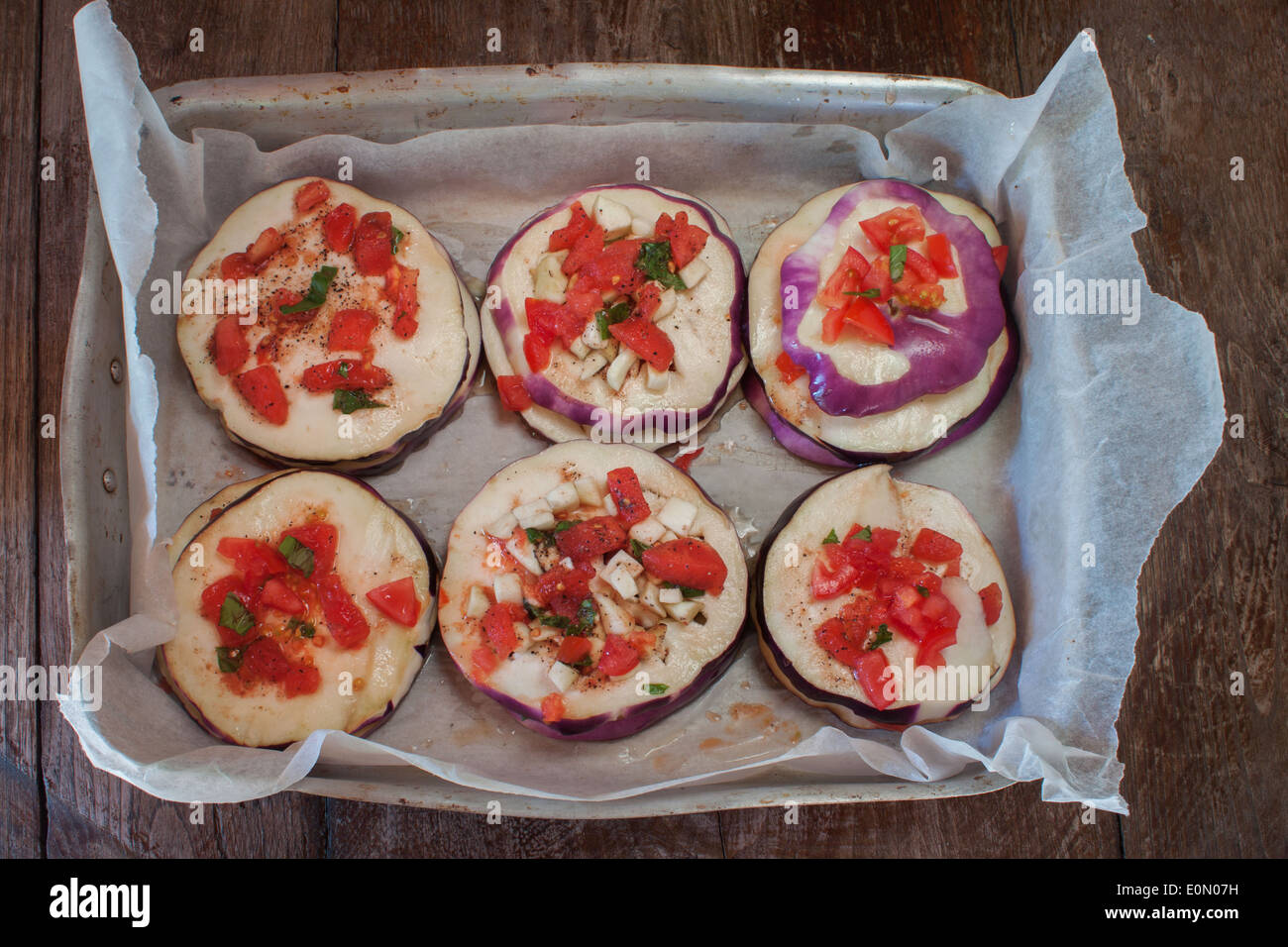 'dripping pan' eggplant slices chopped tomato vegetables recipe cooking prepared 'from above' 'top view' Stock Photo