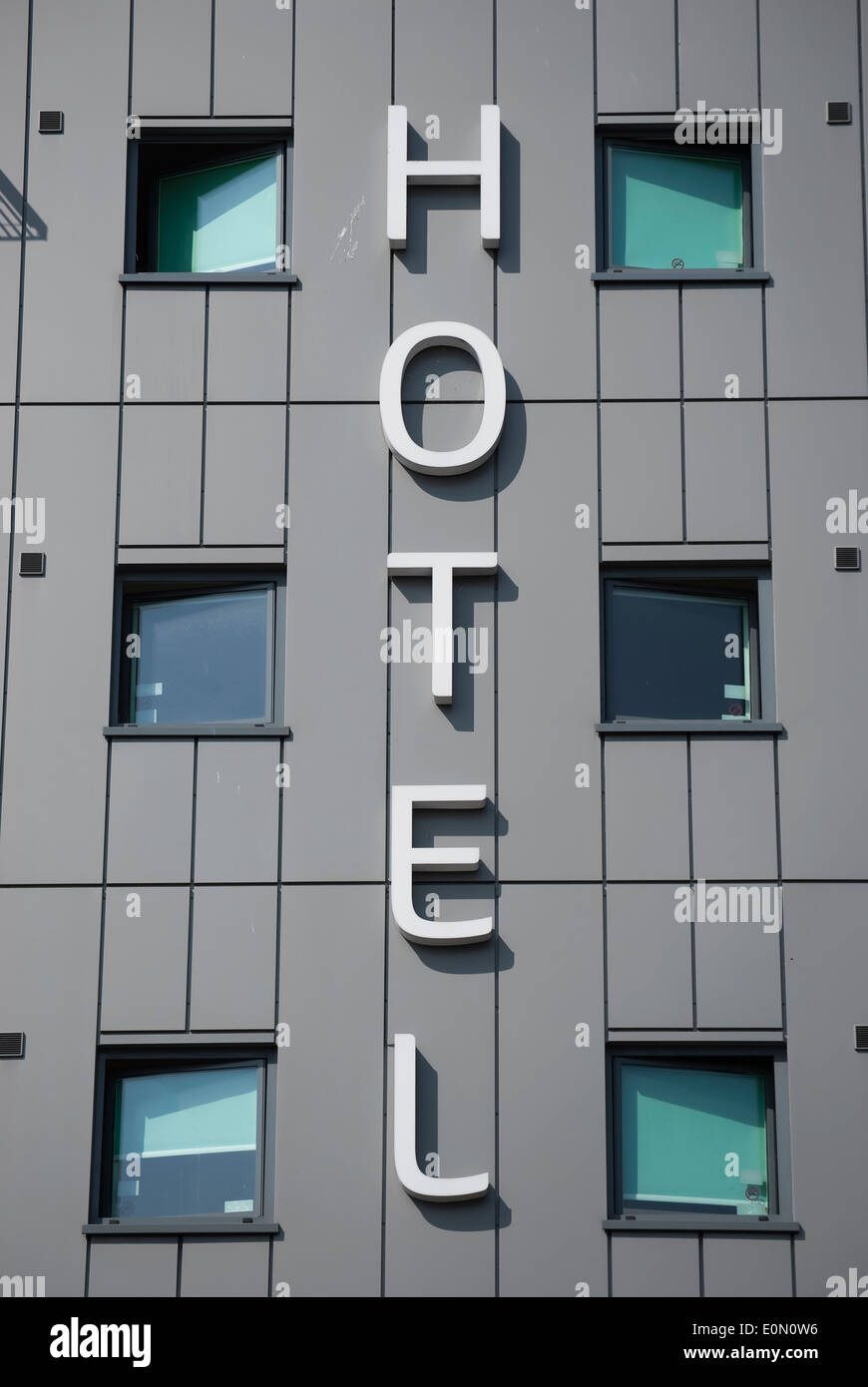 the word hotel between windows on a  wall of an ibis budget hotel in hounslow, middlesex, england Stock Photo