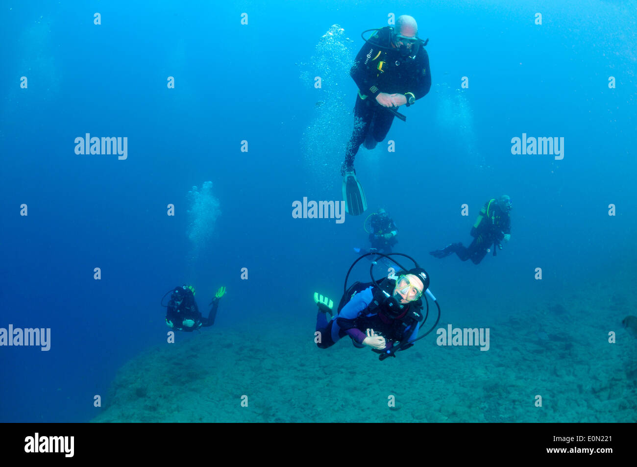Group of scuba divers in blue water, Tenerife Stock Photo
