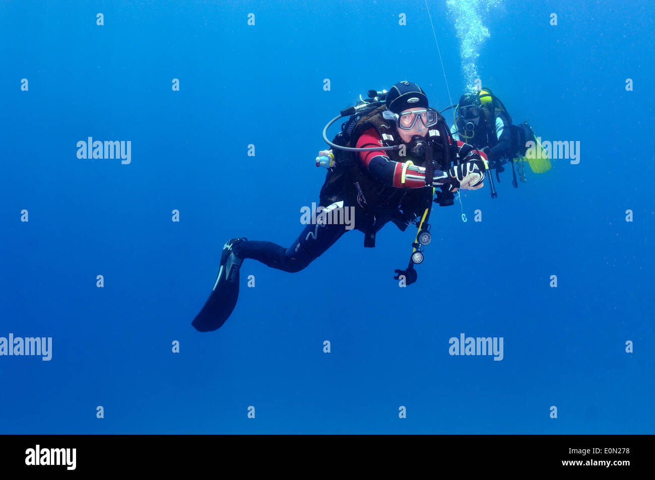 Two scuba divers doing safety stop on line Stock Photo