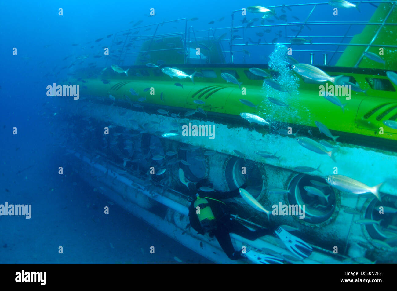 Yellow submarine with scuba diver swimming next to a porthole, Tenerife Stock Photo