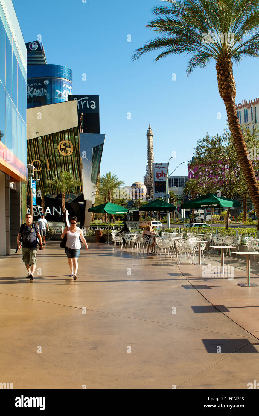 Pedestrians, tourists and visitors on the sidewalk walking along Las