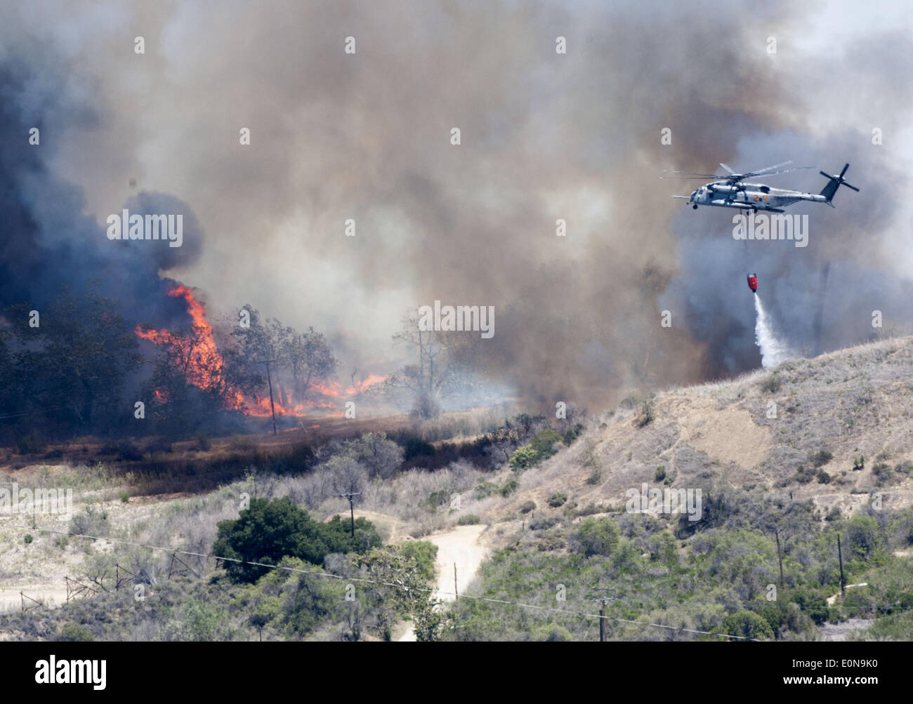 San Clemente, California, USA. 16th May, 2014. A Navy helicopter drops water on the fire line at the Talega Fire on Friday. © David Bro/ZUMAPRESS. Credit:  ZUMA Press, Inc./Alamy Live News Stock Photo