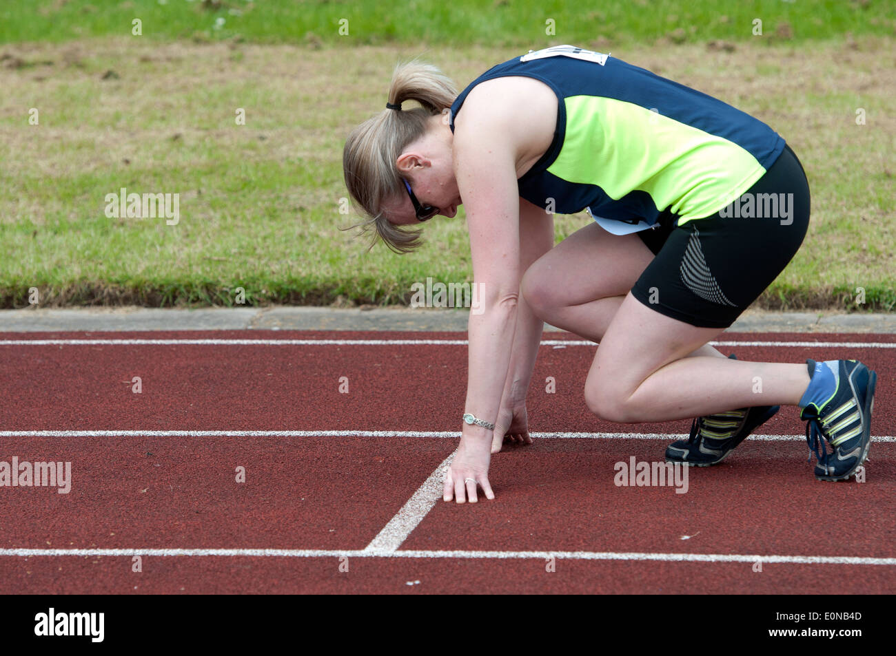 Athletics, woman at start of 400m race at club level, UK Stock Photo