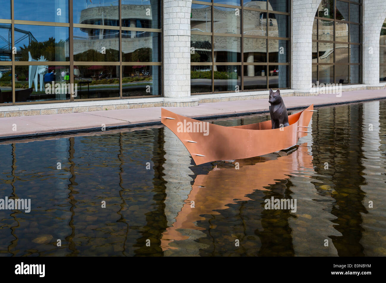 A lone wolf in a canoe exhibit outside the Museum of Civilization in Hull, Quebec, Canada. Stock Photo