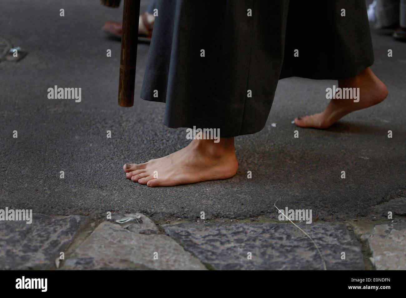 A penitent walks barefoot during the celebration of an easter Sunday palm procession in the island of Majorca, Spain Stock Photo
