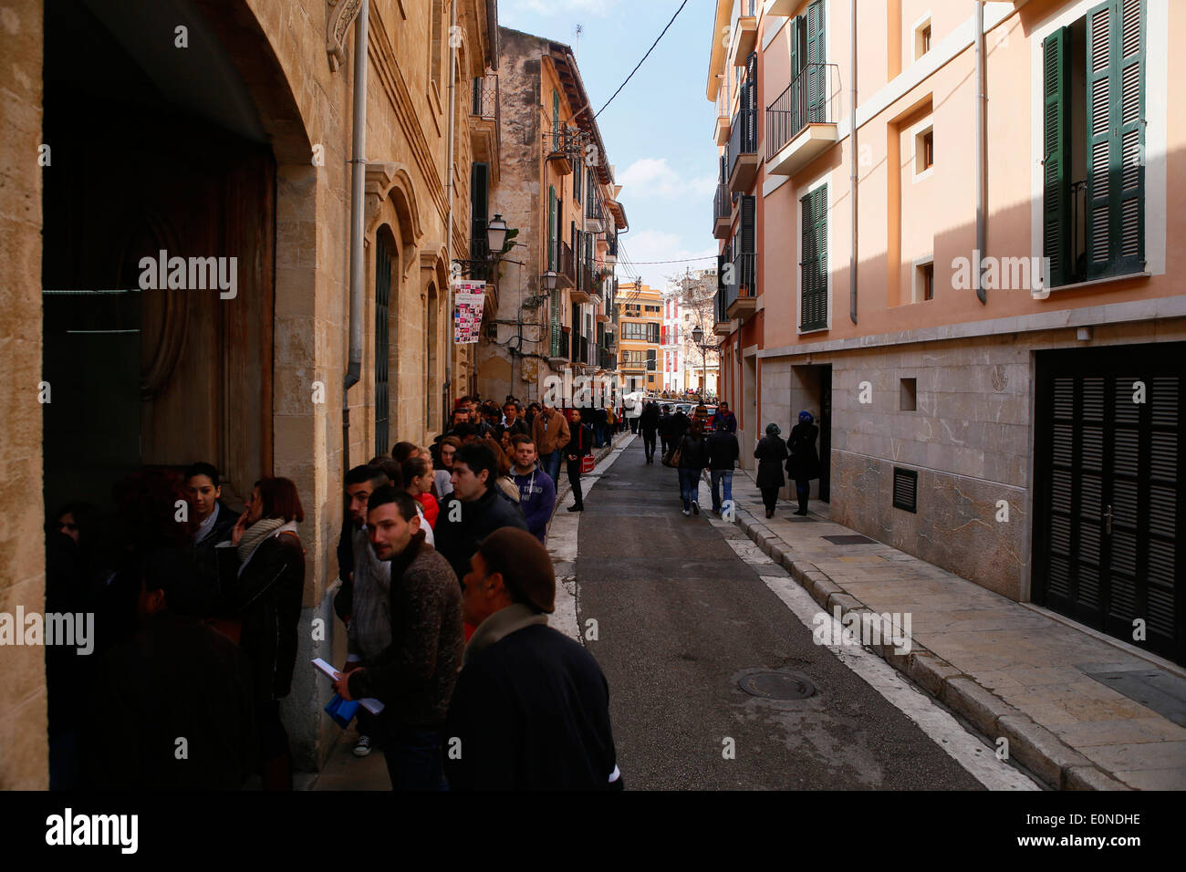 People wait outside an enterprise that is offering 120 temporary workplaces in the island of Majorca, Spain Stock Photo