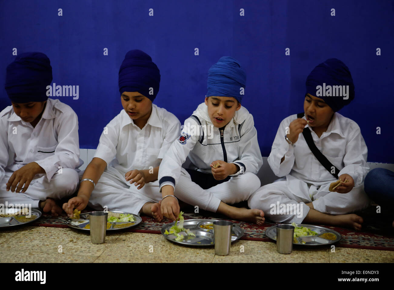 Young Sikhs having their lunch during a Baisakhi celebration amongst diaspora Sikh communith in the island of Majorca, Spain Stock Photo